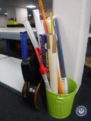 A metal bin of window blinds, coloured perspex rods,