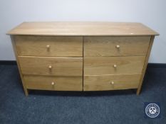 A contemporary oak bowfronted six drawer chest