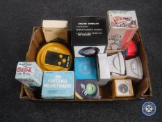 A box of thirteen novelty transistor radios - Coca Cola bottle, American football helmet,