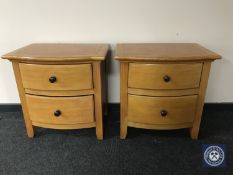 A pair of contemporary pine bowfront two drawer bedside chests
