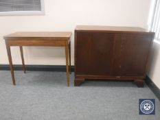 A 20th century oak cupboard and an antique foldover top table