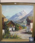 A gilt framed continental school oil painting of an alpine village