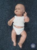 A mid 20th century doll with squeaker