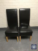 A pair of black leather high back dining chairs