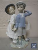 A Lladro figure group of a boy and girl
