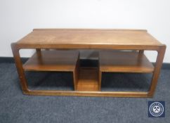 A 1970's teak coffee table with shaped undershelf