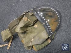 A vintage baby's gas mask and a gas mask in tin