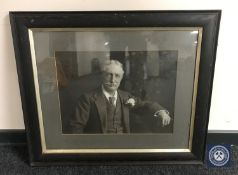 An antiquarian oak framed photograph of a seated gentleman