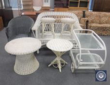 A white wicker two seater settee, two stools, two circular tables,