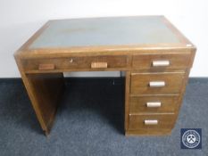 A 20th century oak writing desk fitted five drawers