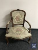 A continental walnut framed salon armchair upholstered in a tapestry fabric