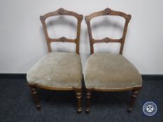 A pair of carved Victorian dining chairs