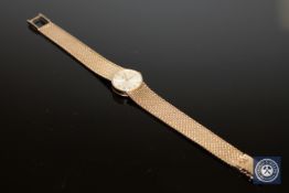 A 9ct gold Omega lady's wristwatch with integral bracelet.
