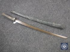 A copy of a Japanese WWII katana in leather scabbard