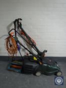 A Black & Decker electric lawn mower together with a Black & Decker strimmer and lawn raker