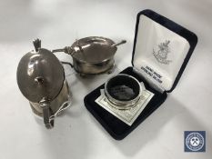 Two silver mustard pots with blue glass liners together with three silver plated mustard spoons and