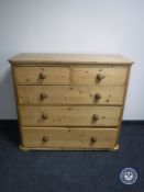 An antique pine five drawer chest