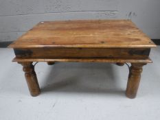 A Mexican pine coffee table with metal mounts