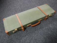 A leather bound shotgun case with combination locks