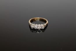 An 18ct gold platinum set four stone diamond ring, size M.