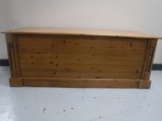 A contemporary pine blanket chest