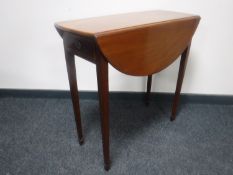 A George IV mahogany drop leaf table fitted a drawer