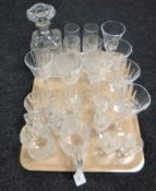 A tray containing assorted lead crystal drinking glasses together with a whisky decanter