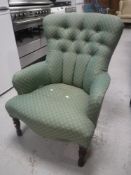 A lady's chairs upholstered in a green buttoned fabric