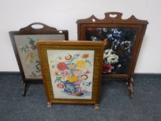 An oak tapestry table screen together with an oak tapestry fire screen and another oak fire screen
