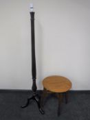 A carved mahogany standard lamp on tripod base together with a circular oak occasional table