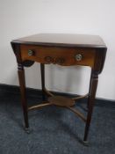A Victorian mahogany flap sided occasional table on ceramic castors
