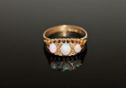 An 18ct gold diamond set three stone opal ring, size O.