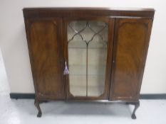 An early 20th century mahogany display cabinet fitted cupboards either side,