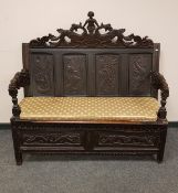 A Victorian carved oak hall seat,