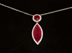 An 18ct white gold ruby and diamond necklace/pendant, a marquise-cut pinkish/red ruby weighing 5.
