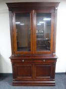 A Victorian mahogany glazed door bookcase fitted a double door cupboard and two drawers beneath