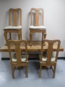 A pine refectory dining table together with a set of four pine Queen Anne style chairs