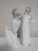 Two Lladro figures; Girl with hands on hips and Girl blowing kiss,