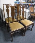 A set of four oak Queen Anne style armchairs