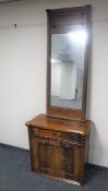 A late 19th century mahogany cupboard and a hall mirror