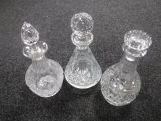 Three crystal decanters with stoppers