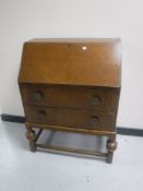 An early 20th century oak bureau fitted two drawers