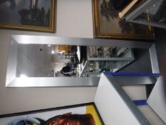 A large contemporary silvered framed hall mirror