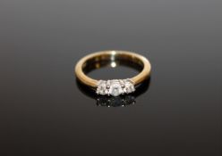 An 18ct gold three stone diamond ring, size I 1/2, approximately 0.25ct.