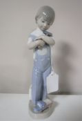 A Lladro figure of a boy with hammer