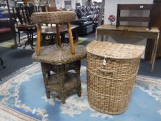 A wicker laundry basket together with an octagonal wicker table and a stool on teak legs