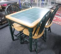 A pine tile topped kitchen table together with four chairs