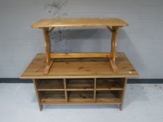 An Ikea pine coffee table fitted shelves beneath together with a further pine refectory coffee