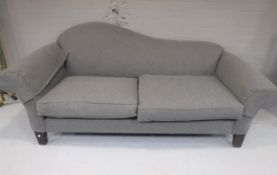 A contemporary chaise settee upholstered in a grey fabric