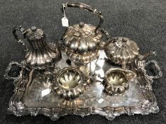 An impressive four piece electroplated tea service with spirit kettle on twin handled serving tray